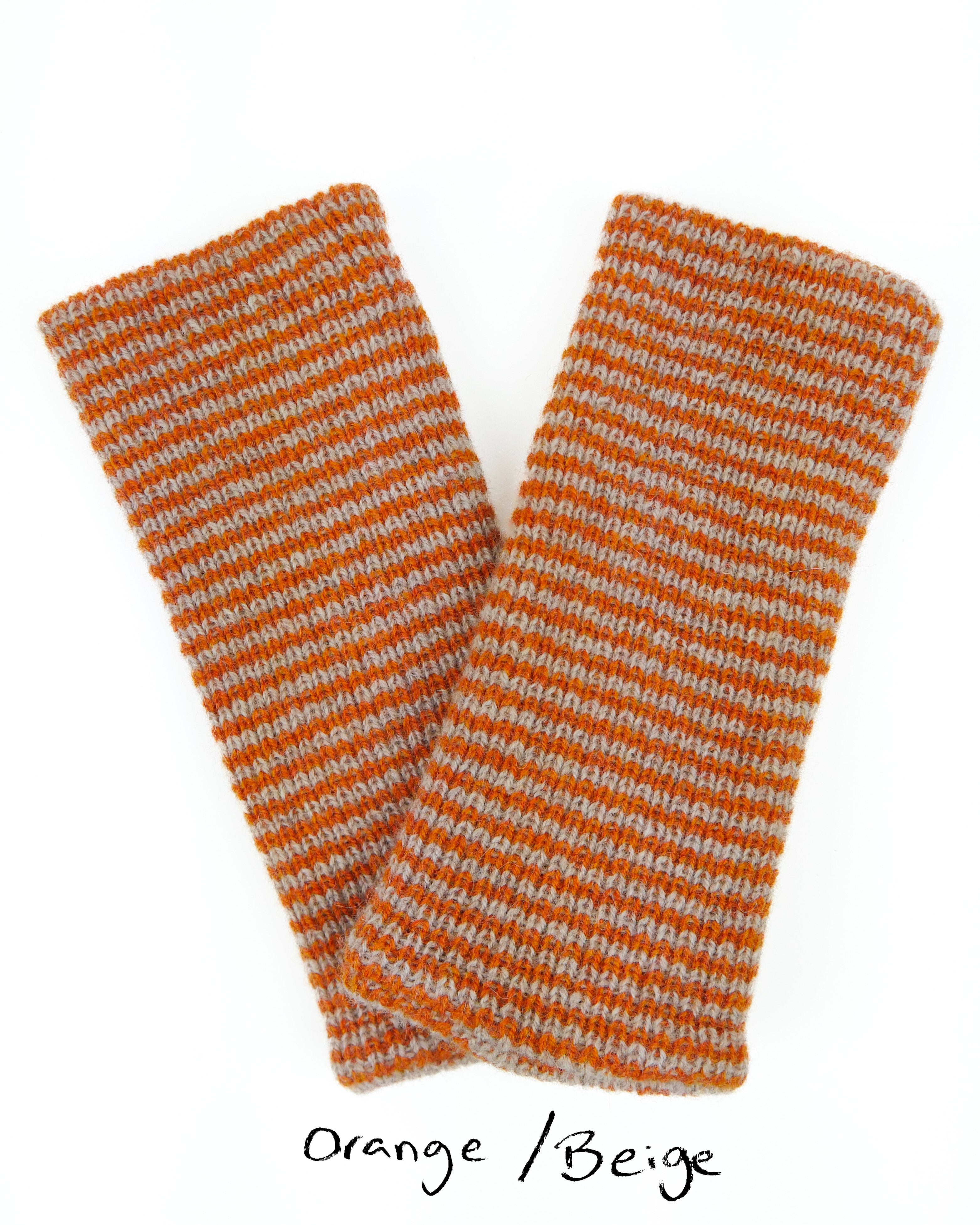 Two knitted wrist warmers in orange and beige on a white background