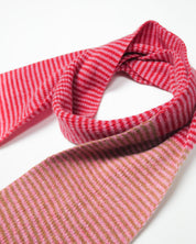 Red, pink and brown striped scarf on a white background.