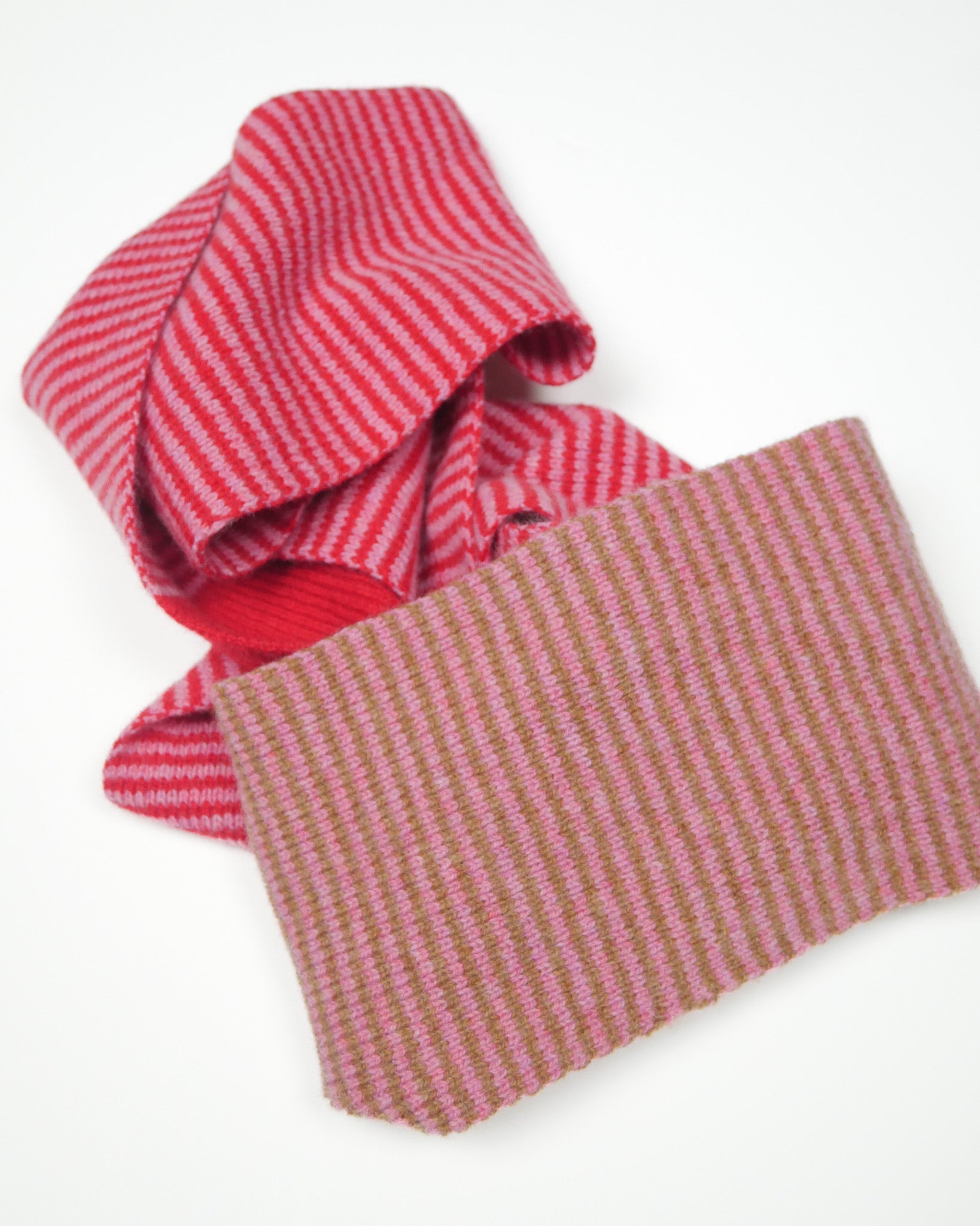 Red, pink and brown striped scarf on a white background.