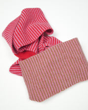 Red, pink and brown striped scarf on a white background.