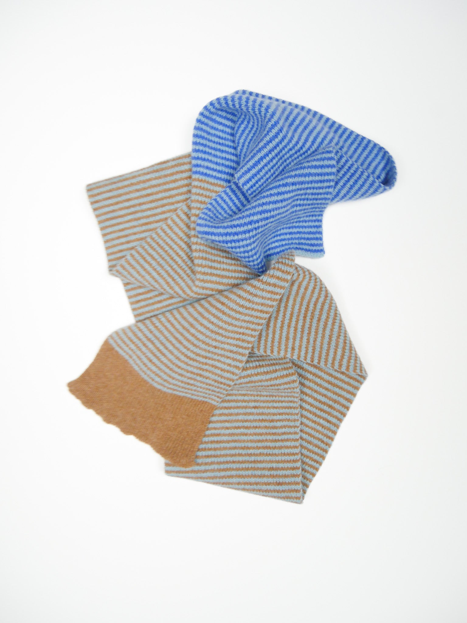 Folded fabric with blue and brown stripes on a white background