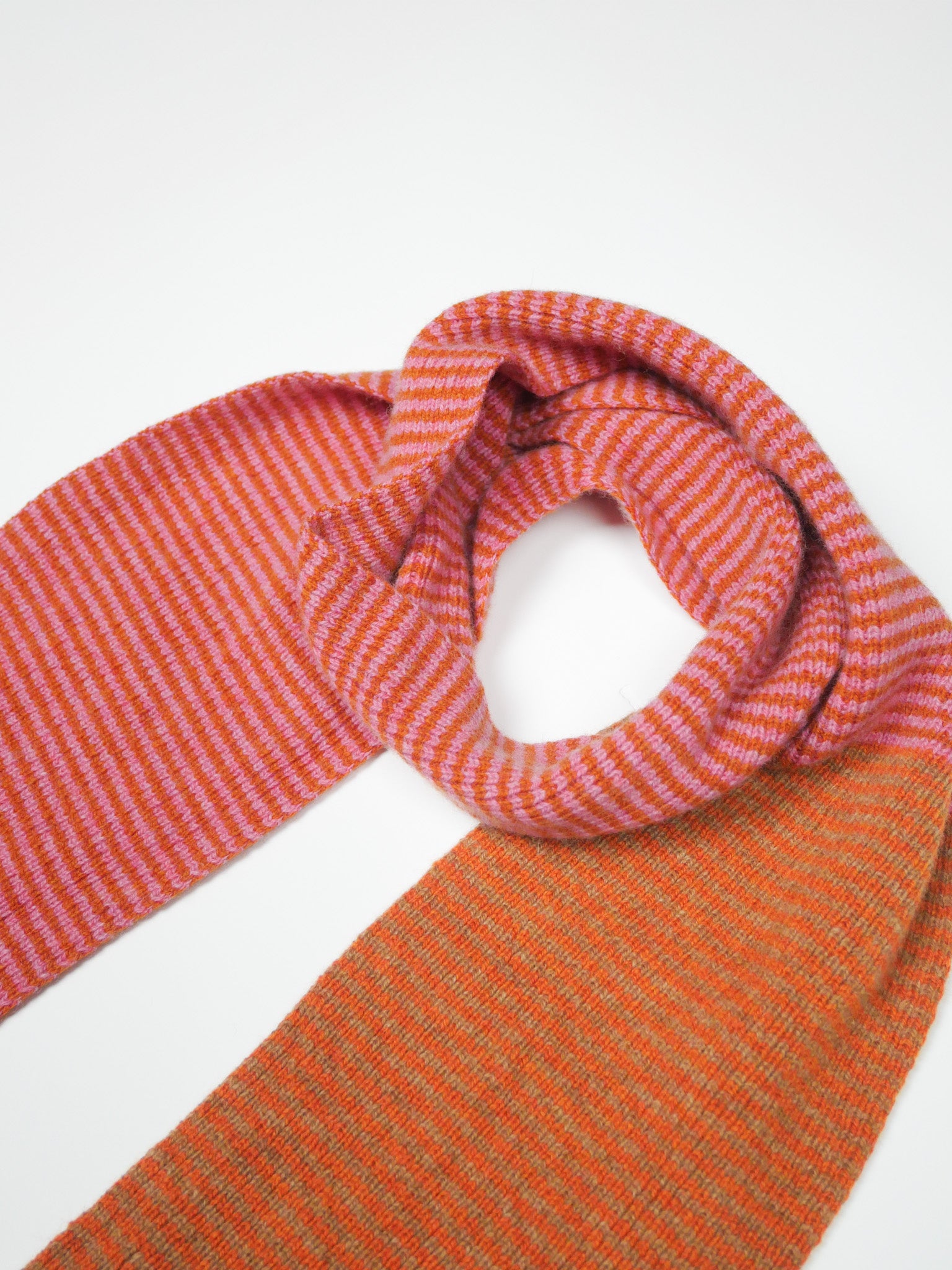 Orange and pink striped scarf on a white background