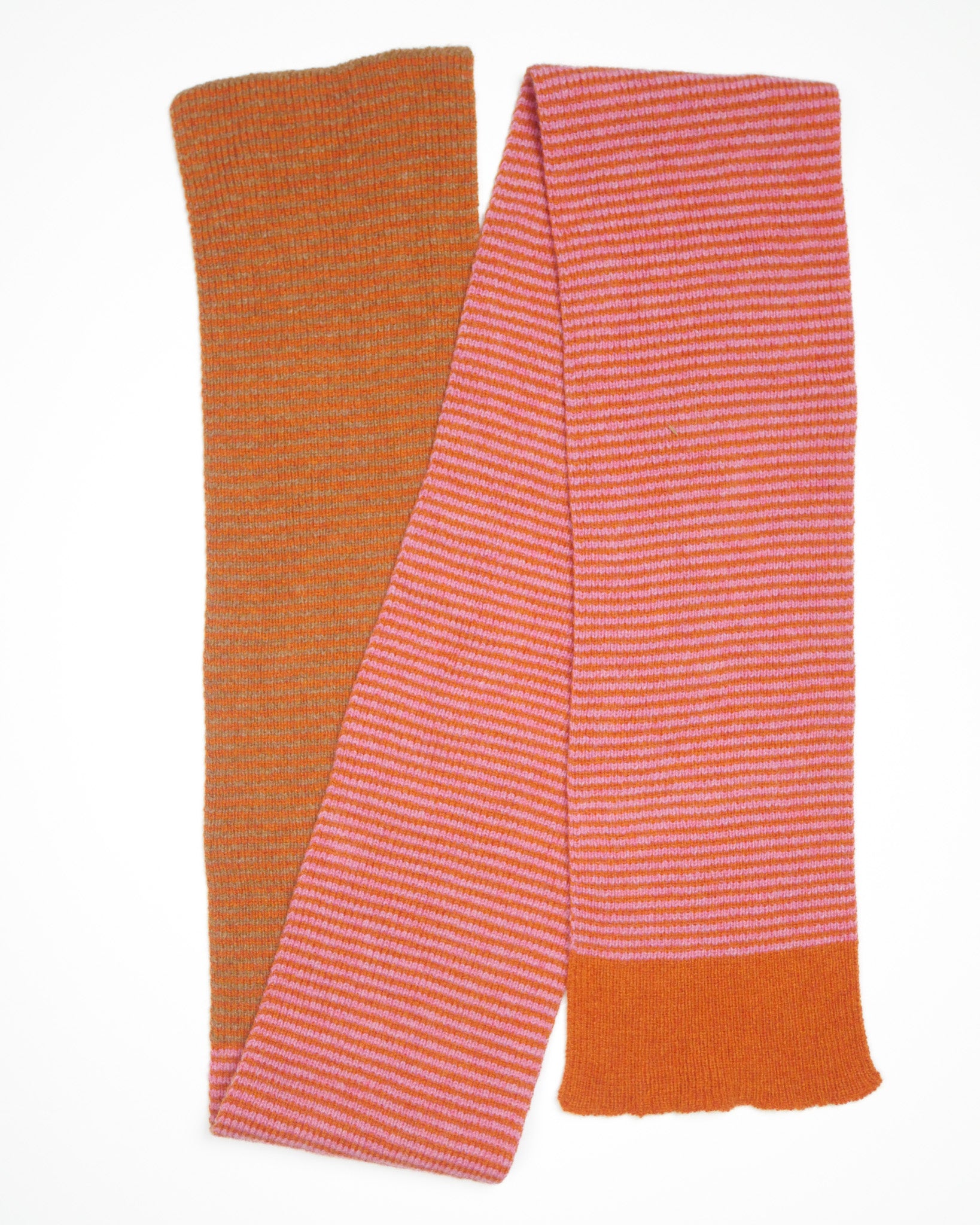 An orange and pink striped scarf on a white backdrop