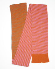 An orange and pink striped scarf on a white backdrop
