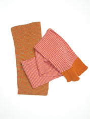 An orange and pink striped scarf on a white background