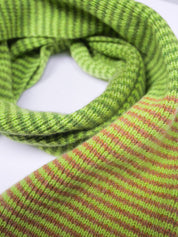 Close-up of a green and brown striped knitted scarf on a white background